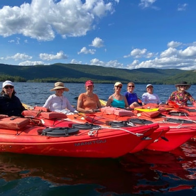 red kayaks lined up on the lake